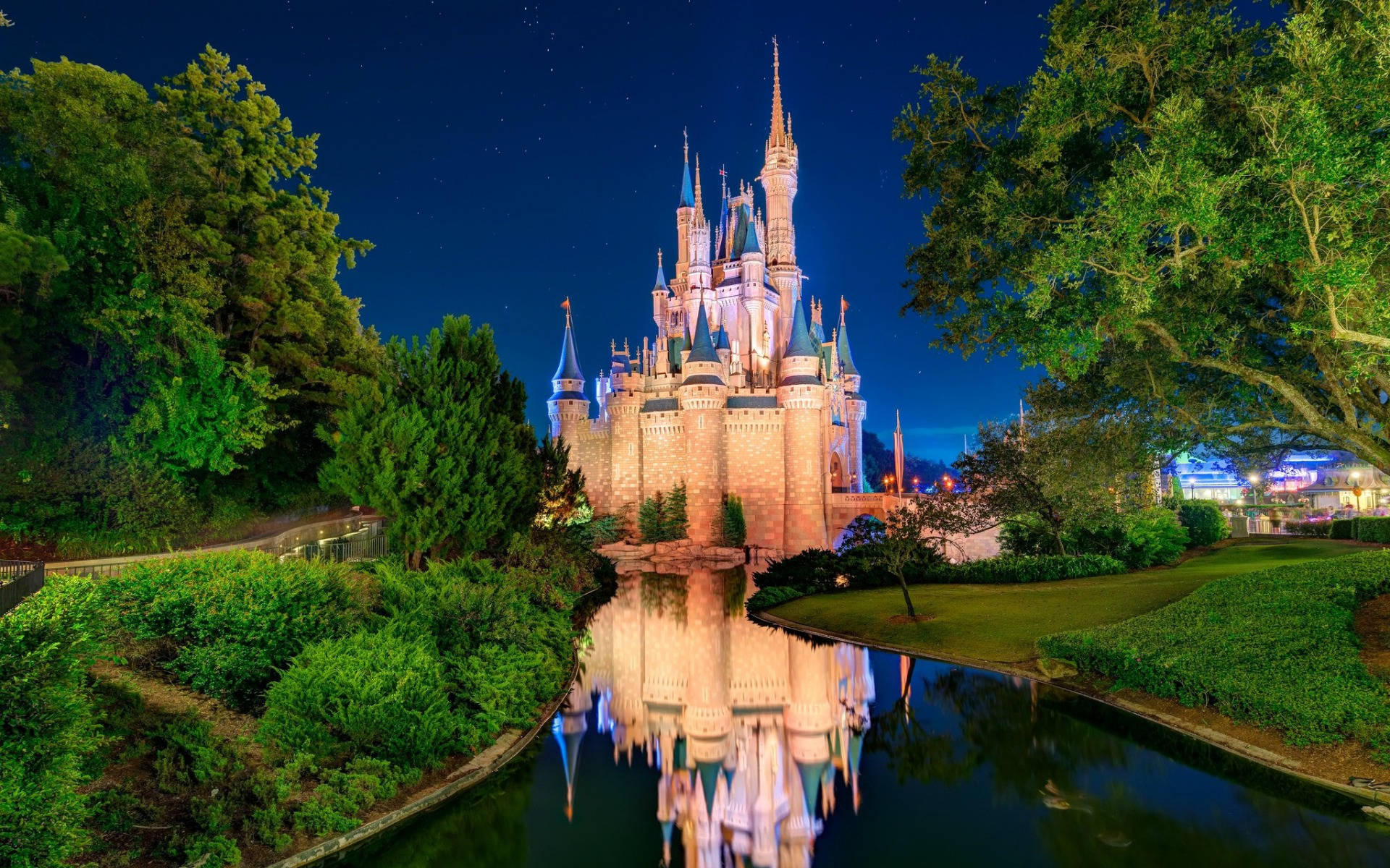 Cinderella Castle lit up and reflected in the water at night